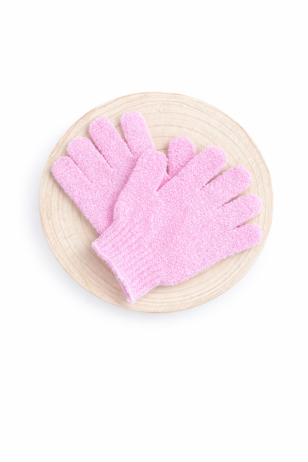 Pink exfoliating gloves on a wooden board with a white background
