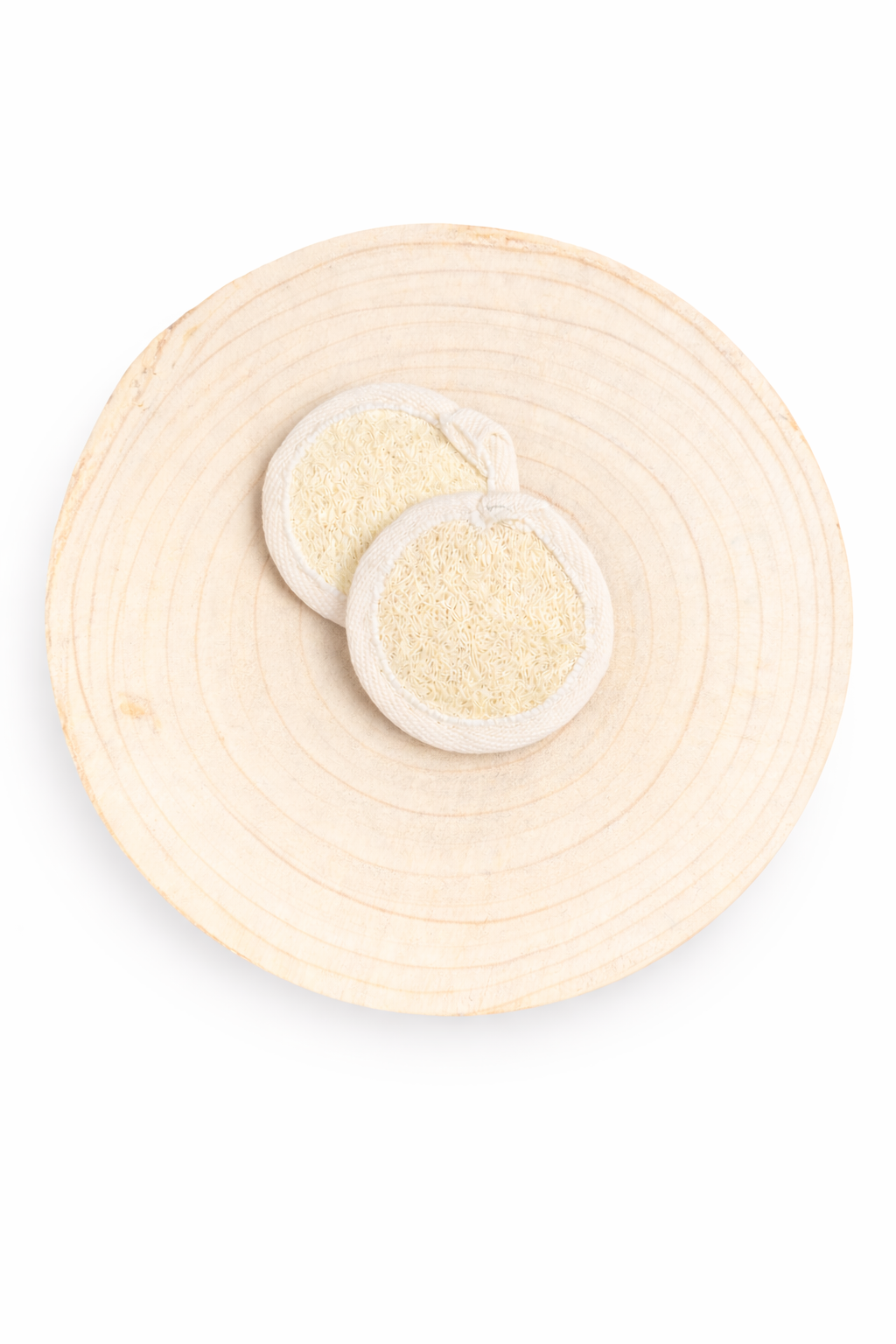 two off white loofah circle shaped on circle wood board and white background