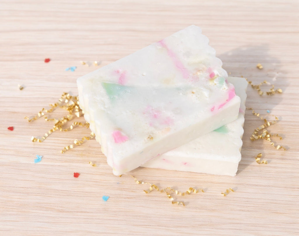 two celebration bars on a wood background with gold crinkle paper and confetti